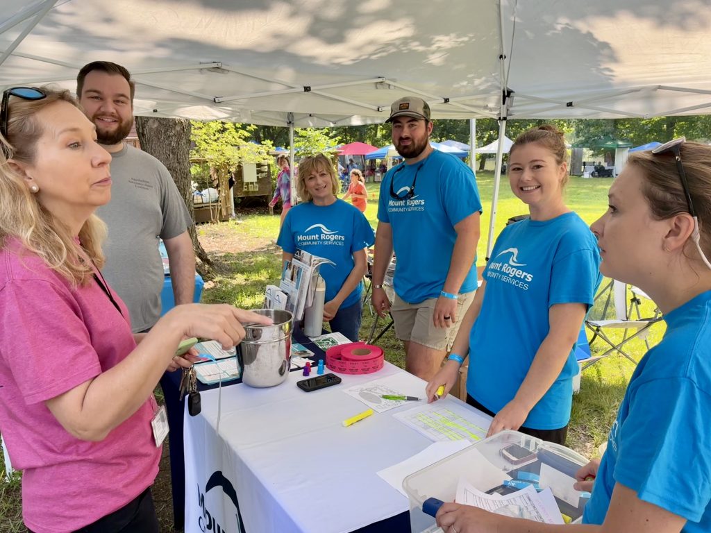 People at booth at wellness fair.